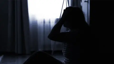 BBC Woman holding her head - generic image