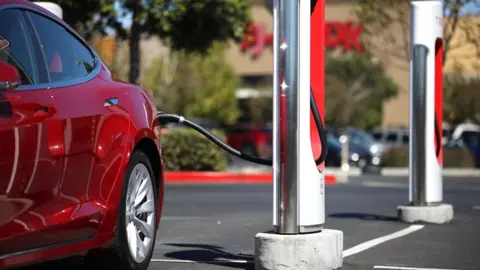 Getty Images A Tesla car sits parked at a Tesla Supercharger on September 23, 2020 in Petaluma, California.