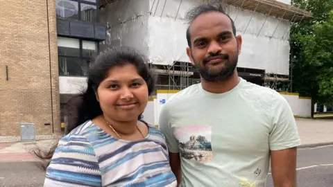 Kate Scotter/BBC Aditya and Anita Majeti, who live in St Francis Tower in Ipswich, outside the building