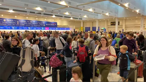 Dean Morley Queues at Gatwick Airport on 27 May