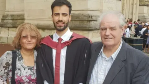 Tim Roberts Mr Roberts and his parents at a graduation service