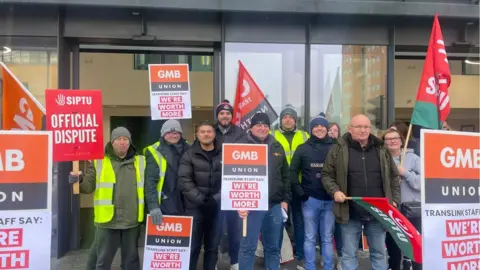 Striking workers with GMB and SIPTU banners