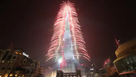 Getty Images Fireworks illuminate the sky around Burj Khalifa, the tallest building in the world, during New Year's 2019 celebrations in the Gulf emirate of Dubai, United Arab Emirates, 1 January 2019