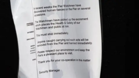 Stewart Whitelaw/Port of Tyne Photograph of sign put up at South Shields pier, asking people not to defecate there