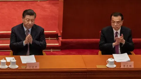 Getty Images Chinese President Xi Jinping, left, and Premier Li Keqiang, right, applaud during the opening session of the Chinese People's Political Consultative Conference at the Great Hall of the People