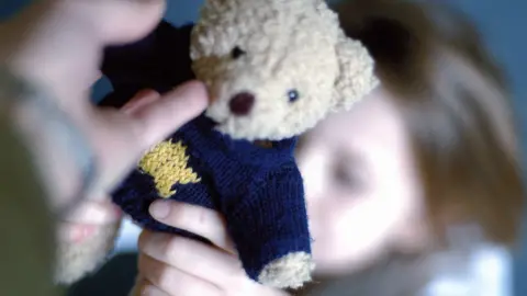 BBC child being handed teddy