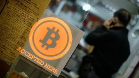 AFP Bitcoin sign in shop