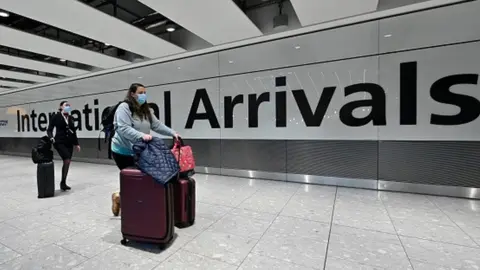Getty Images A woman arriving at a London airport