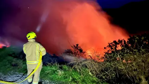 IOM FIRE SERVICE Firefighter tackling blaze