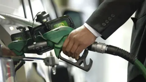Getty Images A man filling his car with petrol