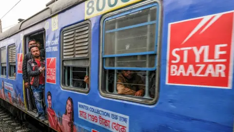 Getty Images KOLKATA, WEST BENGAL, INDIA - 2023/01/31: Commuters travel in a local suburban train. (Photo by Dipayan Bose/SOPA Images/LightRocket via Getty Images)