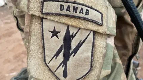 BBC/Ed Habershon An insignia of a lightning strike on a soldier's uniform in Somalia