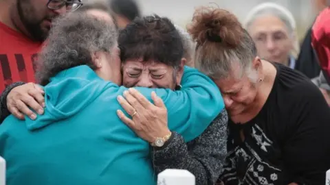 Getty Images Mourners are comforted during a memorial service for the 26 people killed at the First Baptist Church of Sutherland Springs, Texas (10 November 2017)