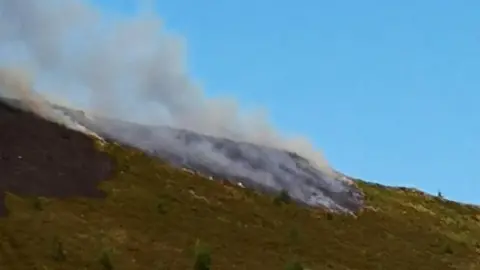 Kelly George Nearby residents had hoped that the fire on Maerdy mountain had stopped on Saturday morning, but flames are quickly spreading again