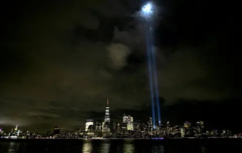 Mike Segar/REUTERS Beams of light shine above the skyline of lower Manhattan