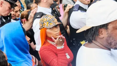 Getty Images Nicki Minaj surrounded by police and fans