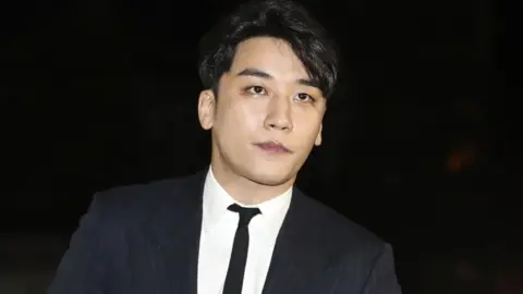 Getty Images Seungri arrives at a police station in Seoul for questioning (27 Feb 2019)