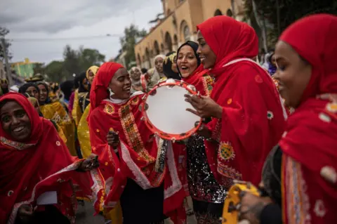 MICHELE SPATARI/AFP Women chant and dance during the celebration for the Shuwalid festival in Harar. Shuwalid is an annual festival celebrated by the Harari people of Ethiopia and marks the end of six days of fasting to compensate omissions during Ramadan.