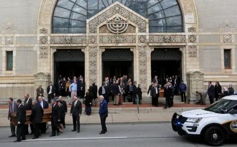 Reuters Caskets are carried from Rodef Shalom Temple after funeral services for brothers Cecil and David Rosenthal,