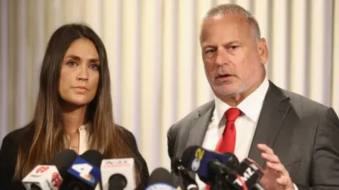 Getty Images Dominique Huett with her attorney Jeff Herman