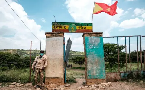 Getty Images An armed member of the community security stands in front of a school where a polling station is located during Tigrays regional elections, in the town of Tikul, 15 kms east from Mekele, Ethiopia, on September 9, 2020.