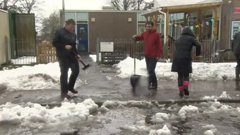 BBC Parents helped to clear snow to allow Creigiau primary school, near Cardiff, to reopen on Monday