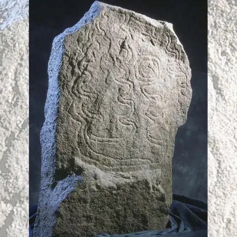 National Museum Wales Standing stone decorated with carved zig-zag patterns on its surface