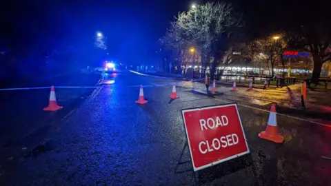 BBC The police cordon on Kennedy Way