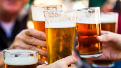 Getty Images People drinking pints of beer