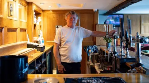 Landlord John Turner in his pub The Dolphin