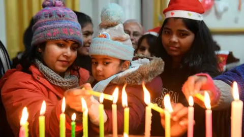 AFP Christian devotees light candles on Christmas Day at St.Paul Church in Amritsar