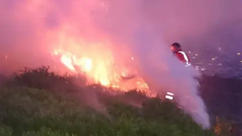 South Wales Fire and Rescue Service Firefighters tackling the blaze at Maerdy mountain