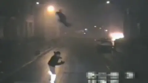 WYFRS Image of a person throwing an object at a fire appliance