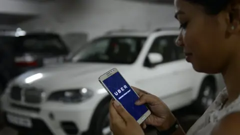 Getty Images BENGALURU, INDIA - OCTOBER 01: UBER cabs booking using mobile app on October 01 2015 in Bengaluru, India.