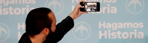 EPA Nayib Bukele takes a selfie with supporters