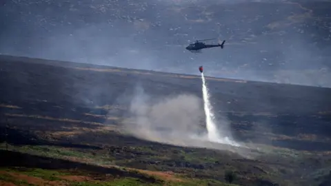 AFP/Getty Images Helicopter working at Saddleworth Moor