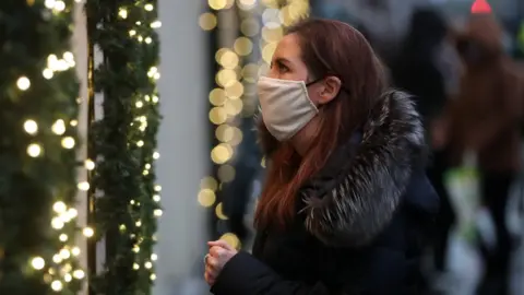PA Media woman looking in christmas window