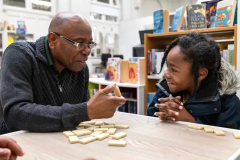 Jim Grover Jeremiah learning to play dominoes