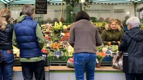 BBC A farmer's market in Munich - vegetables on sale