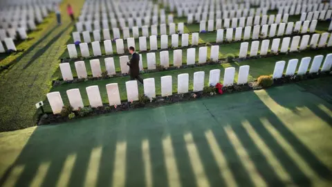 Getty Images Visitors walk amongst rows of headstones at Tyne Cot Commonwealth War Graves Commission cemetery on March 24 2014 in Passchendaele, Belgium.