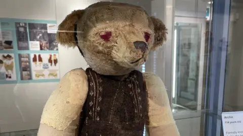 Oxfordshire Museum old teddy bear wearing brown jacket