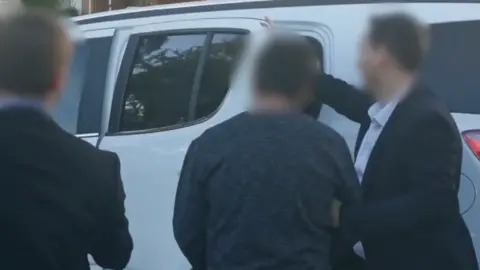 AFP A police-blurred image of a man who was arrested