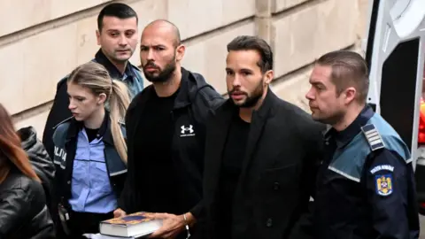 GETTY DANIEL MIHAILESCU Andrew Tate and his brother Tristan Tate arrive at a courthouse in Bucharest for a pre-trial hearing
