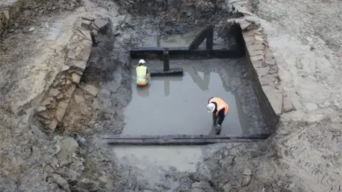 Cotswold Archaeology Timbers and stone piers from a mid-15th century bridge across the moat