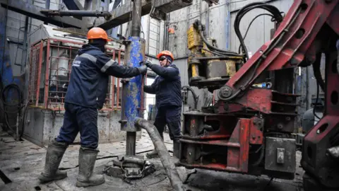 Getty Images Workers on a Gazprom gas rig in Western Russia