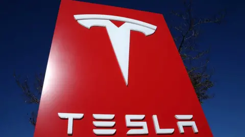 Getty Images Tesla logo in a sign posted in a Tesla showroom