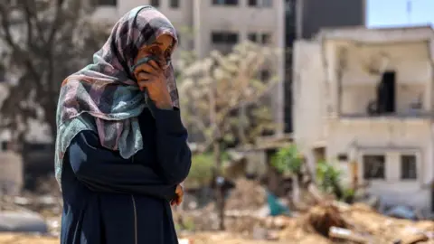 AFP A woman reacts as she watches Palestinian forensic experts and others search for bodies of dead people in the vicinity of Al-Shifa Hospital in Gaza City