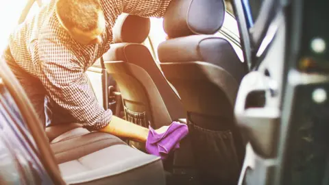 Getty Images A man washing the inside of a car