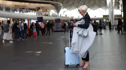 Hollie Adams A traveller at Kings Cross station on June 25, 2022