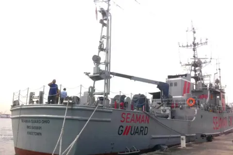 STRDEL Indian personnel stand on the deck of the Seaman Guard Ohio at a dock in Tuticorin in October 2013.